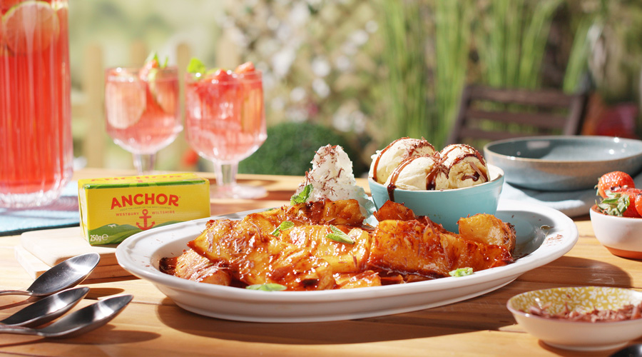 Grilled pineapple dessert topped with sauce and whipped cream