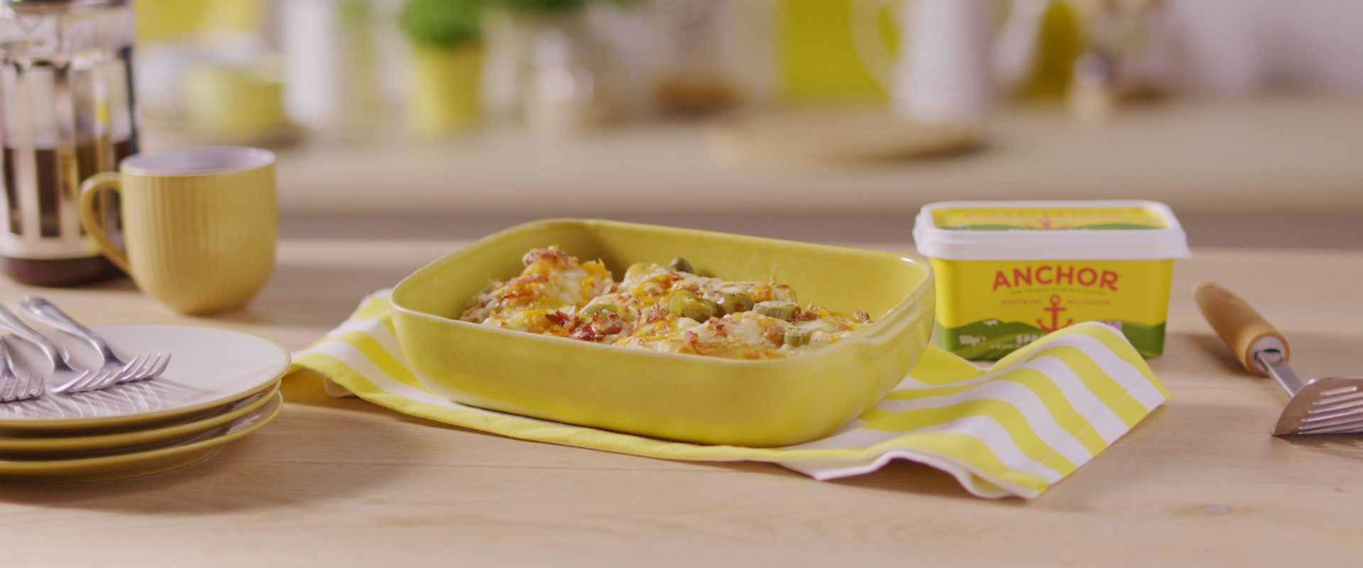 Loaded hash browns with tub of Anchor Butter