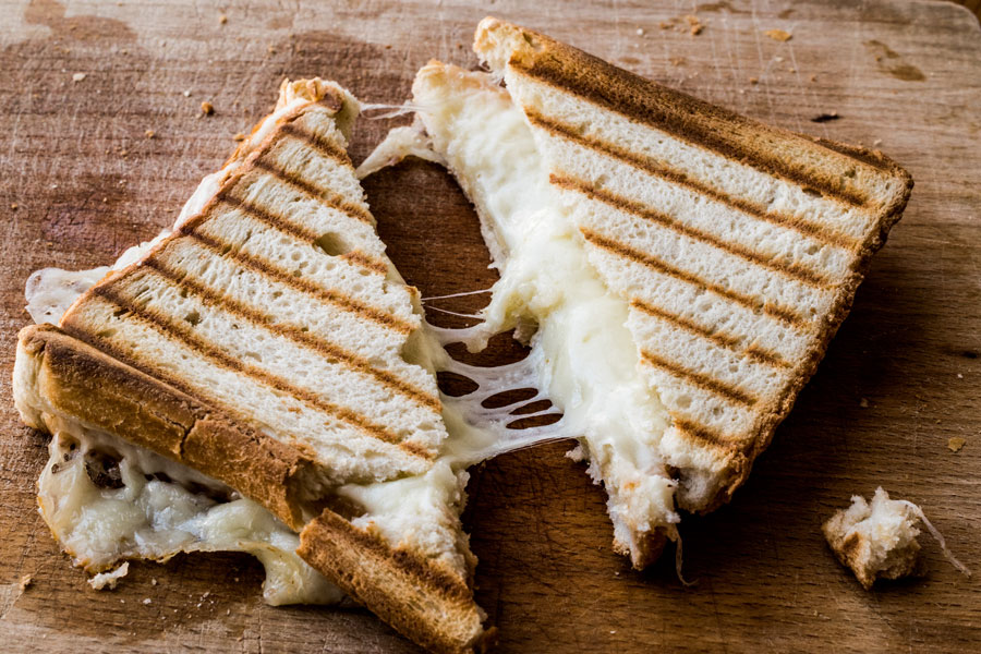 Cheese toastie with filling on board